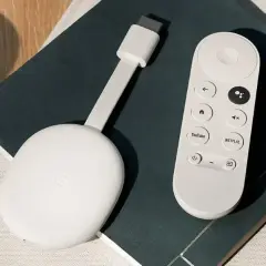 Biały Chromecast z pilotem, gotowy do podłączenia do telewizora. Ułatwia strumieniowanie ulubionych treści.