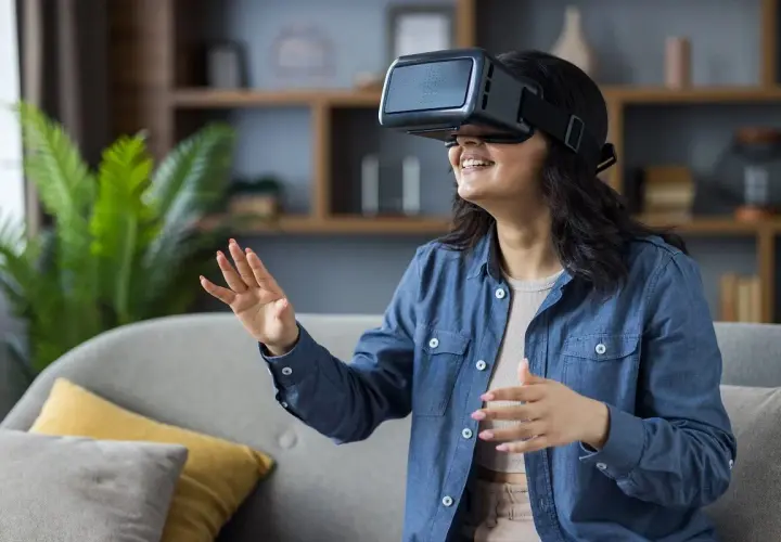 Kobieta w okularach VR, odkrywa jak zbudowane są okulary VR, zanurzając się w wirtualnym świecie.