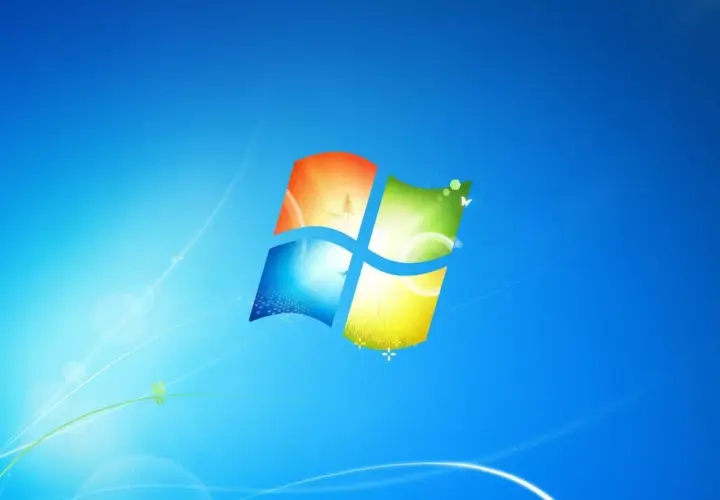 Ikona systemu Windows 7 na niebieskim tle z delikatnymi, świetlistymi liniami i motylami.
