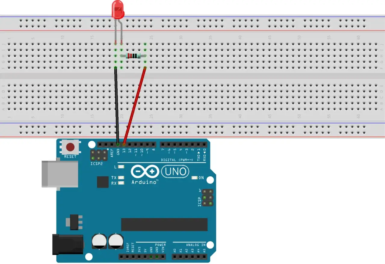Arduino Uno podłączone do płytki stykowej z diodą LED i rezystorem. Dioda LED świeci, gdy prąd przepływa przez obwód.